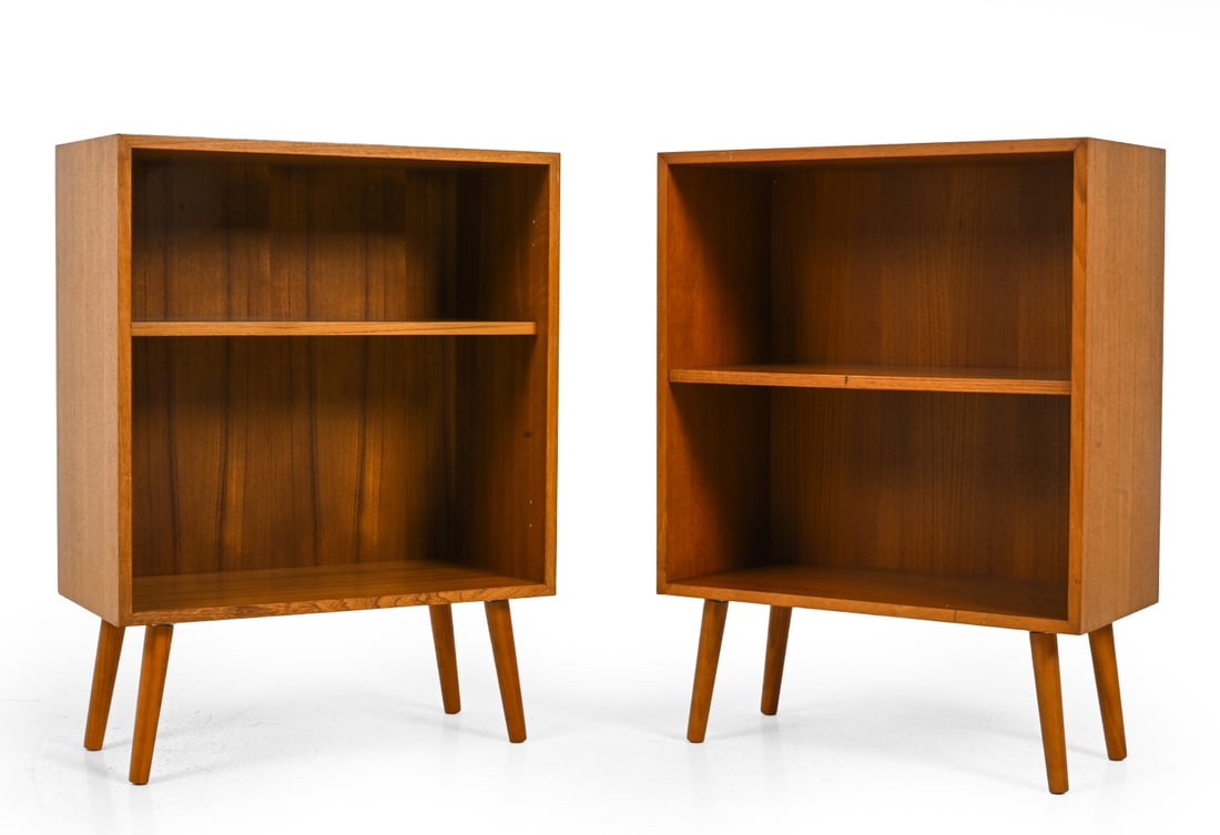 PAIR OF DANISH TEAK BOOKCASES C. 1960S: Denmark, circa 1970s. Dimensions: H 32'' x W 24'' x D 12" Condition: Nicks, light scratches, rubs, minor sun fading. Wear consistent with age and use.