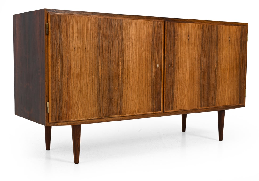 POUL HUNDEVAD DANISH ROSEWOOD CABINET C. 1960S: Stamped on backside. Includes key. Dimensions: H 29.75" x W 54.5" x D 17.25" Condition: Heavy fading/discoloration. Scuffs to side. Wear consistent with age and use.