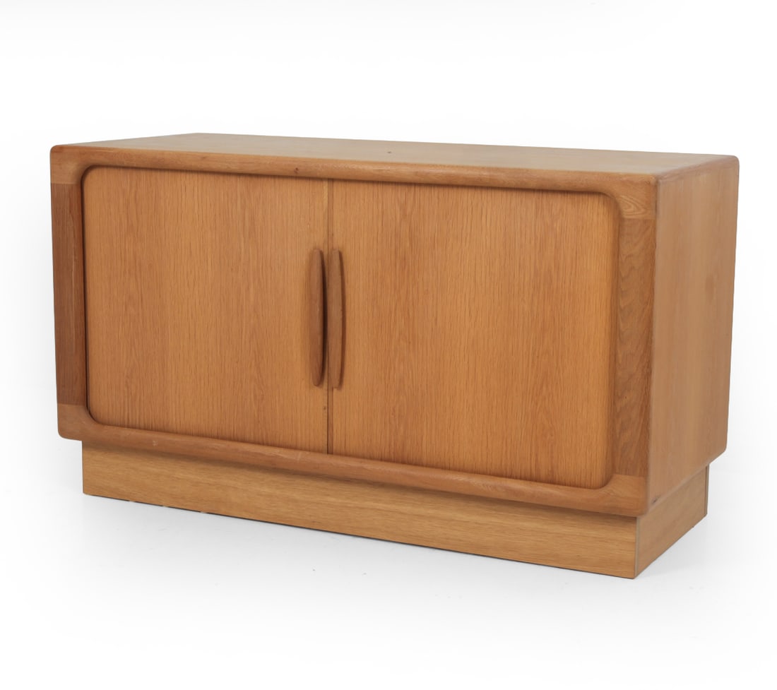 DYRLUND DANISH OAK TAMBOUR MEDIA CABINET: Media cabinet featuring tambour doors with bracket dividers and drawers to interior. Apparently unmarked. Dimensions: H 28" x W 49? x D 20.5? Condition: Some sun fading, scratches and scuffs. Water st