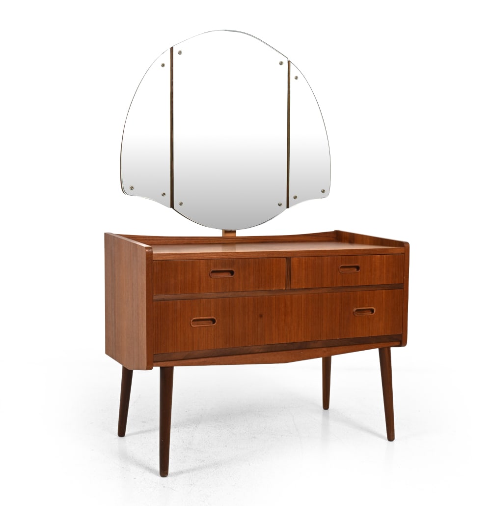 DANISH TEAK VANITY DRESSING TABLE C. 1970S: Teak dressing table with triptych mirror and drawers with recessed pulls. Denmark, circa 1970s. Dimensions: H 54" x W 35.5" x D 18" Condition: With some sun fading to top. Veneer loss top, right, and