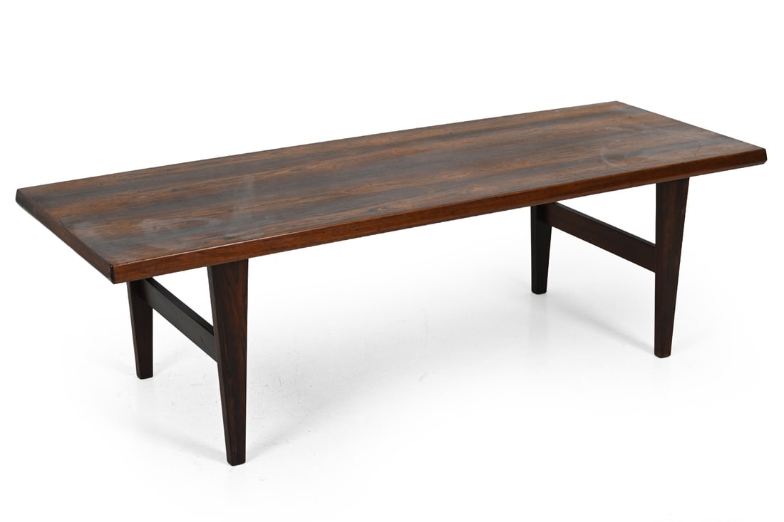 SVANTE SKOGH STYLE ROSEWOOD COFFEE TABLE C. 1960S: Rosewood coffee table with a rectangular top and tapered legs. Sweden, circa 1960s. Dimensions: H 20'' x W 67'' x D 23" Condition: Showing signs of wear including scratches, scuffs to finish