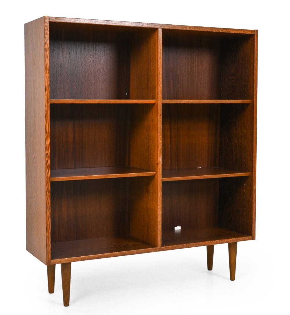 ATTR. POUL HUNDEVAD DANISH OAK BOOKCASE 1960S: Oak frame with tapered legs and shelves. Apparently unmarked. Denmark, circa 1960s. Dimensions: H 49.25" x W 42.75" x D 12.25" Condition: Fading and discoloration. Light scuffs and marks. Cut holes