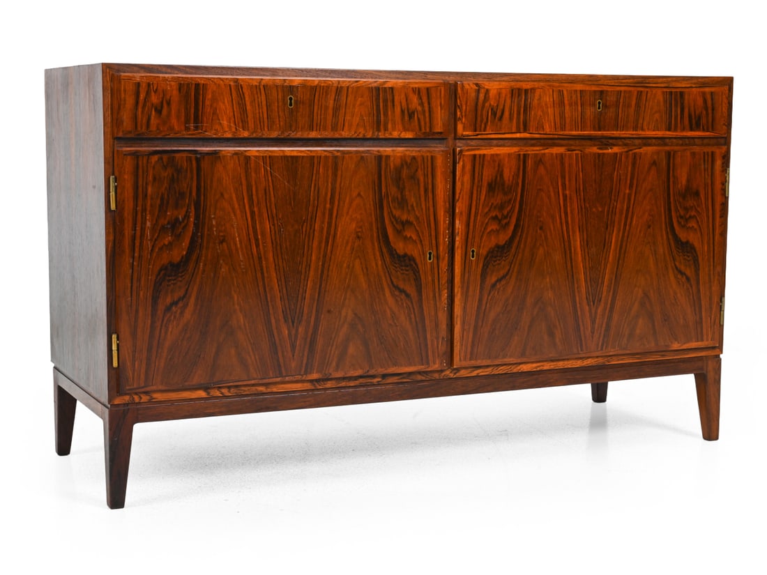 OMANN JUN MODEL 5 DANISH ROSEWOOD CABINET C. 1960S: Marked inside the drawer. Key included. Rosewood veneer cabinet. Denmark, circa 1960s. Dimensions: H 27.75" x W 47.5" x D 17" Condition: Sun fading. Scuffs to edge of cabinet doors. Wear consistent wi
