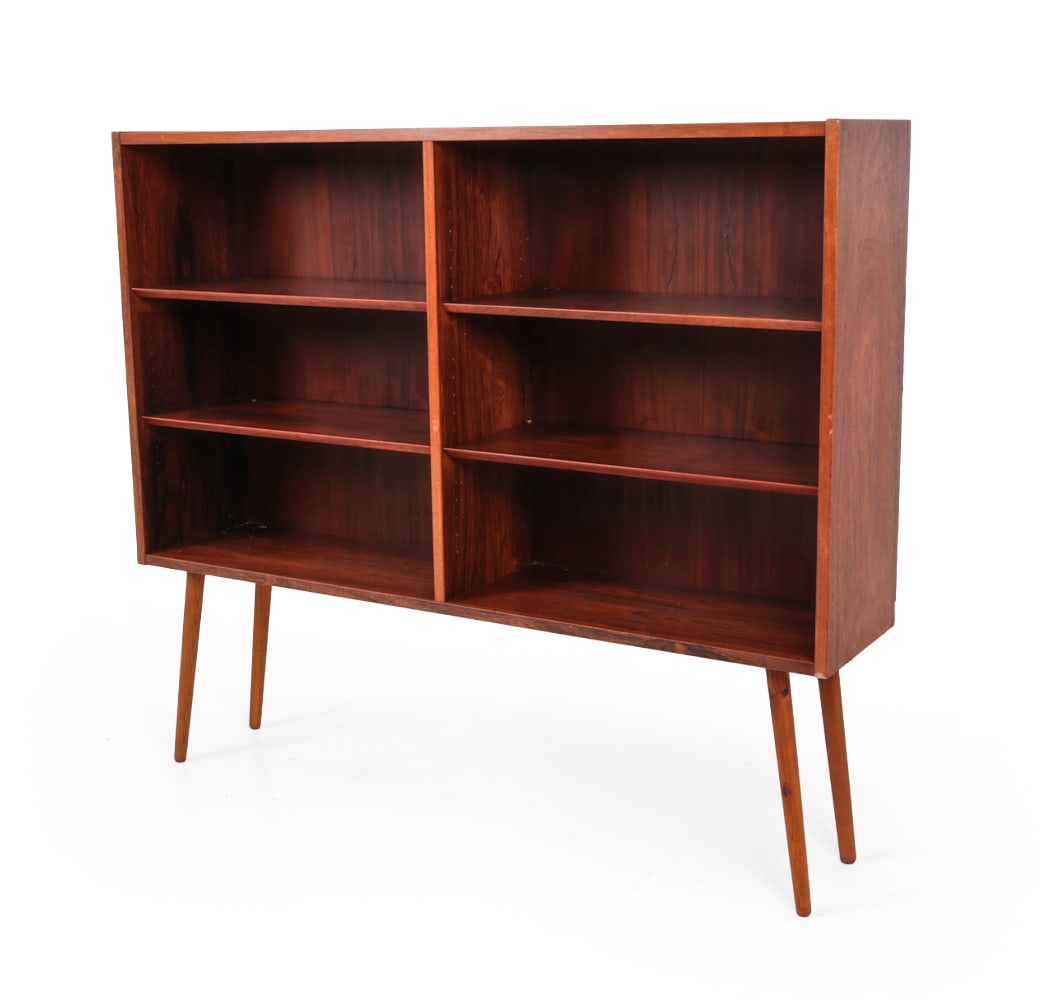 HUNDEVAD DANISH ROSEWOOD BOOKCASE C. 1960S: Adjustable shelves. Stamped on backside. Dimensions: H 47.5" x W 54.5" x D 12" Condition: Legs possibly not original, water stains to backside, losses to veneer, wear consistent with age and use.
