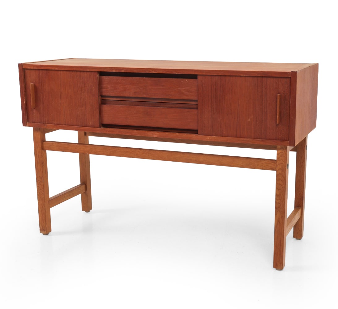 SWEDISH TEAK CONSOLE CABINET C. 1960S: Teak frame with sliding doors and drawers. Sweden circa 1960s. Dimensions: H 22 " x W 33.5? x D 12? Condition: Some scratches, water stains and sun fading. Wear consistent with age and use. 118