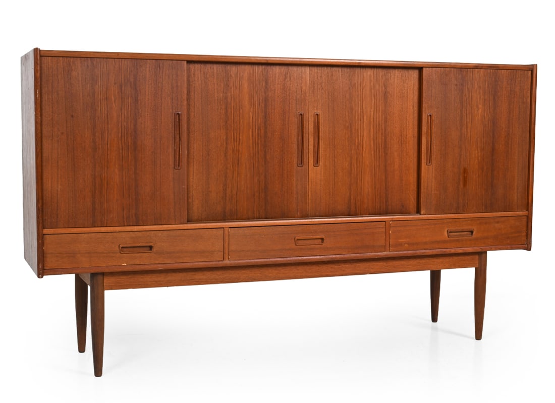 WESTERGAARD STYLE DANISH TEAK SIDEBOARD C. 1960S: Teak sideboard with sliding doors, recessed pulls and lower drawers. Denmark, circa 1960s. Dimensions: H 44" x W 77" x D 17.5" Condition: A few scuffs. Loss to front drawer. Wear consistent with age a