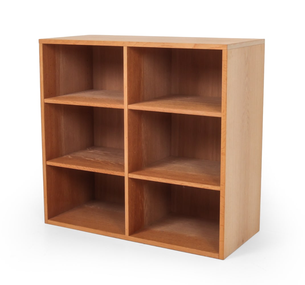 TRANEKAER DANISH OAK BOOKCASE: Mid century oak bookcase by Tranekaer Furniture with six open compartments. Denmark, Circa 1960s. Dimensions: H 33.5" x W 35.5 " D 16" Condition: Few scratches, loss of wood on shelf. Wear consistent