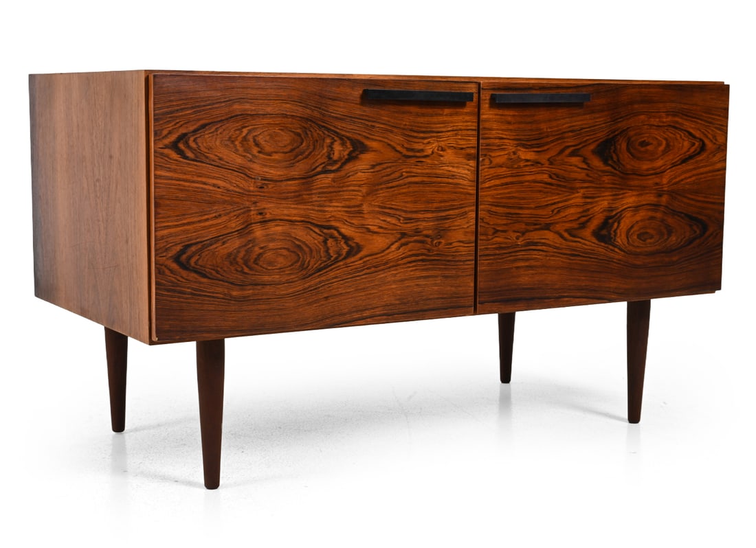 IB KOFOD-LARSEN FOR FAARUP DANISH ROSEWOOD CABINET: Rosewood cabinet with interior shelves and metal pulls. Marked on backside. Dimensions: H 26" x W 45.5? x D 23? Condition: Few light scratches, scuffs. Sun fading to front. Wear consistent with age an
