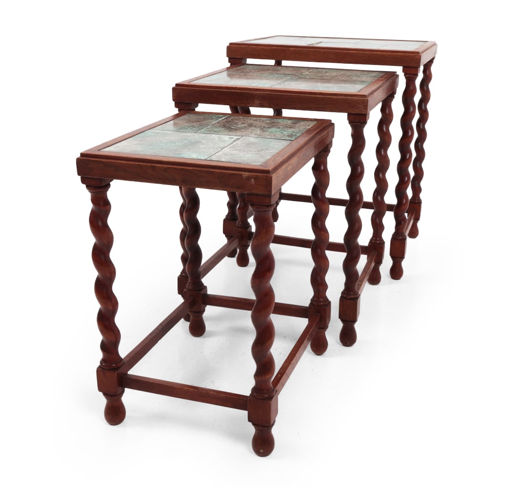 DANISH TURNED OAK & TILE NESTING TABLES C. 1970S: (3) Oak frame with inlaid tile tops. Barley-twist legs. Denmark, circa 1970s. Dimensions: (Largest) H 20" x W 16.75" x D 13.75" Condition: Chip to tile on largest table. Tile in uneven surface. Minor 