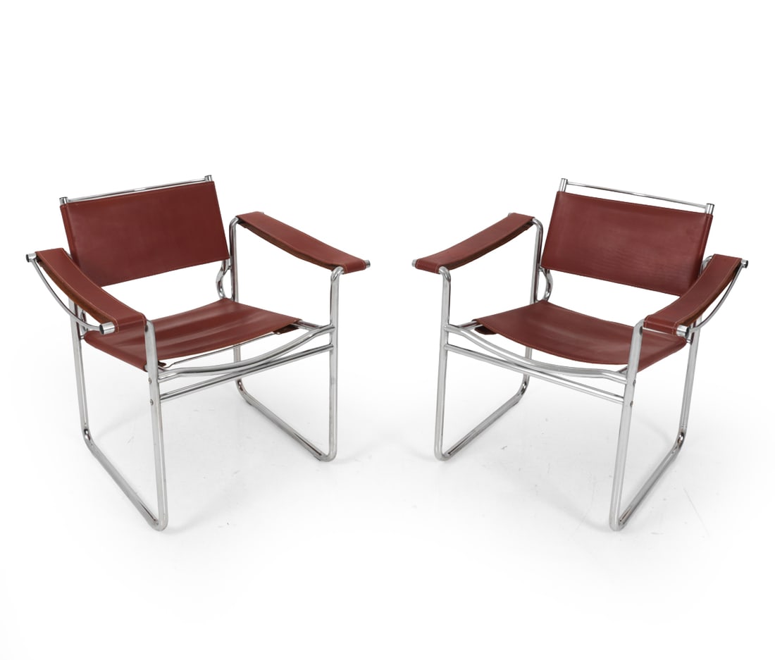PAIR OF WASSILY BREUER STYLE ARM CHAIRS: Tubular chrome frame with red leather upholstery. Apparently unmarked. Dimensions: H 27.75" x W 27" D 29" SH 16.25" Condition: Previous glued cracking to one armrest, could use additional reinforcemen