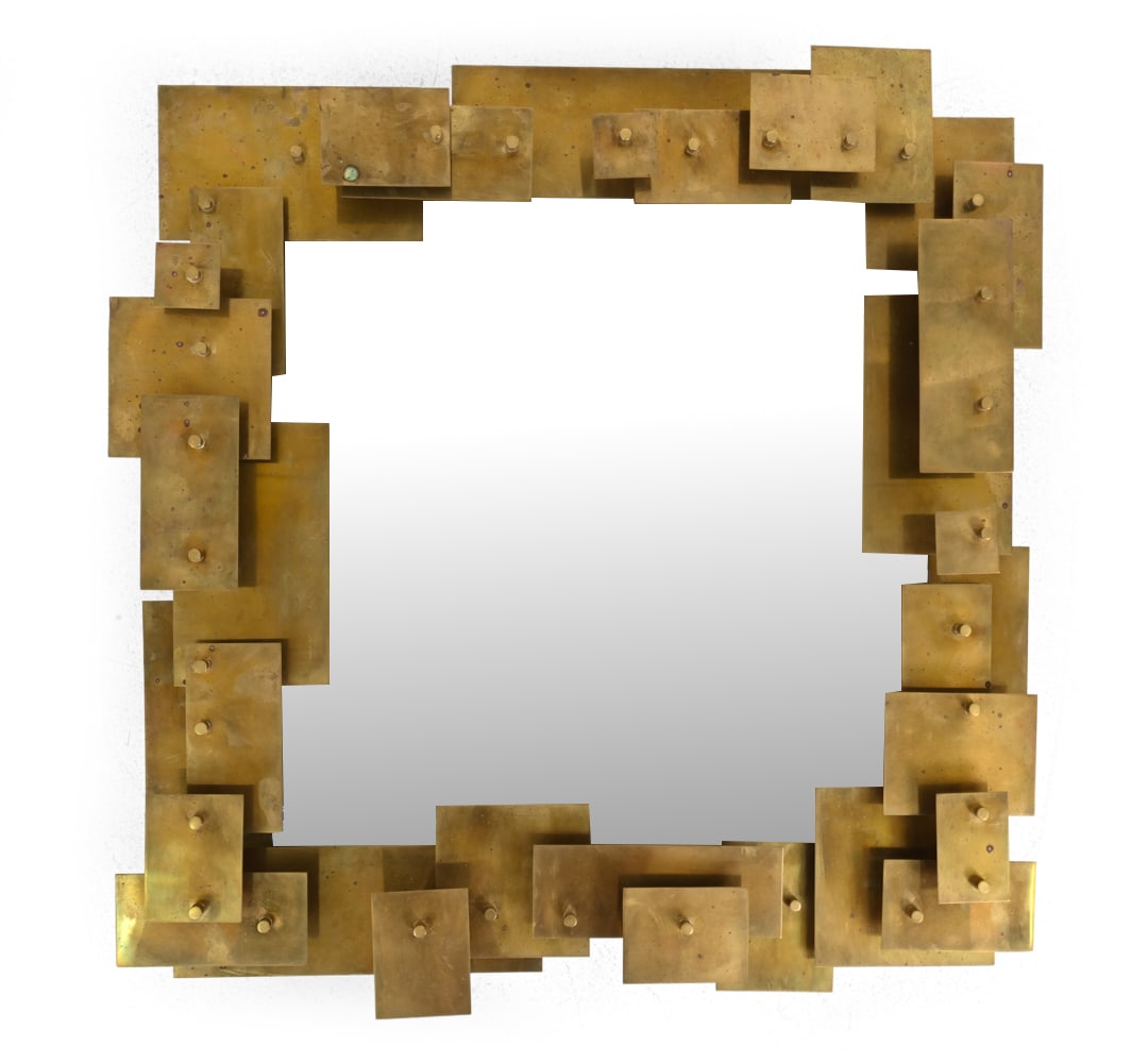 JONATHAN ADLER BRASS PUZZLE WALL MIRROR: Mirror with layered sheets of solid brass in an architectural design. Labeled on backside. Dimensions: H 31'' x W 30'' x D 4" Condition: Patina and discoloration. Light surface wear consistent with ag