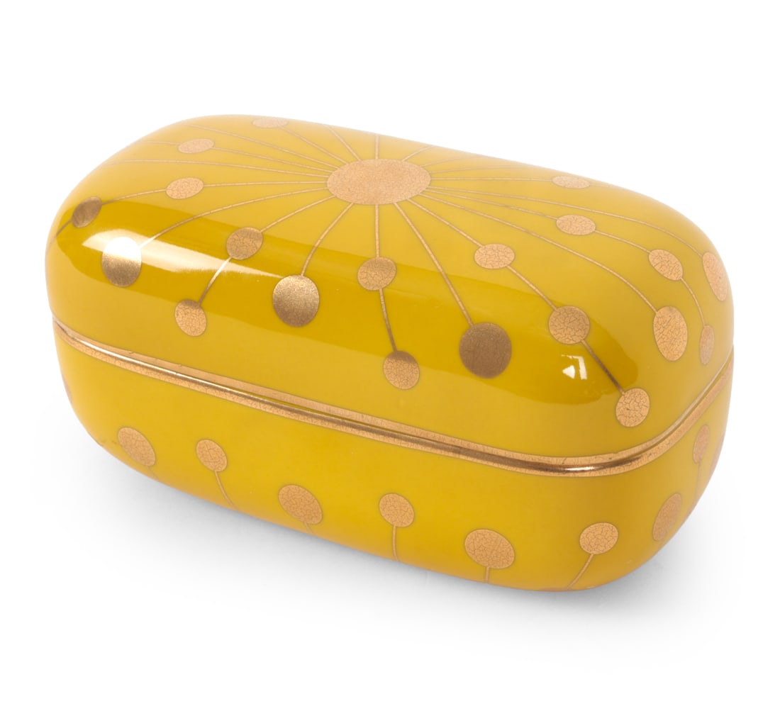 JONATHAN ADLER SANTORINI PANDORA PORCELAIN BOX: Yellow porcelain lidded trinket box with gold accents. Labeled on underside. Dimensions: H 4" x W 7.25" x D 3.75? Condition: Wear consistent with age and use including light rubs and scuffs.