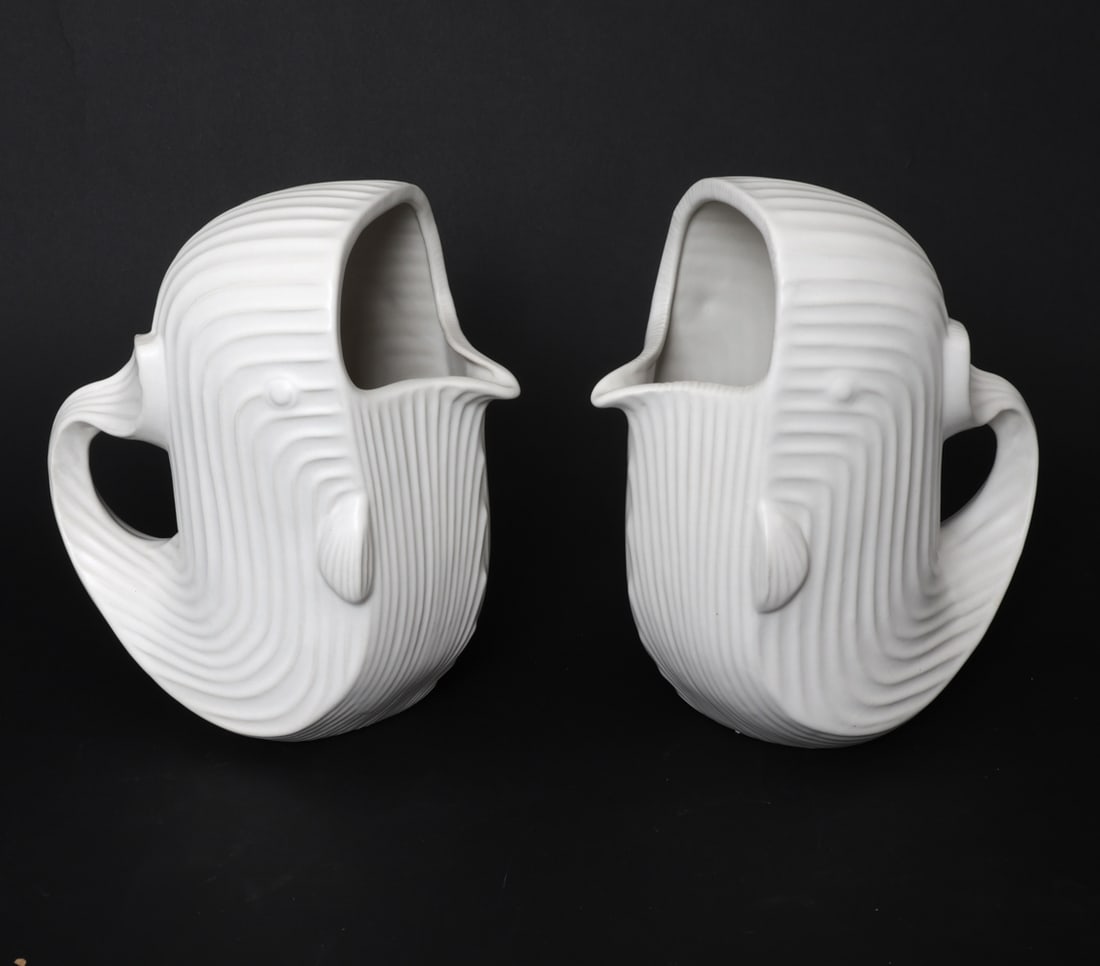 PAIR OF JONATHAN ADLER MENAGERIE WHALE PITCHERS: Pair of ceramic pitchers with ribbed designs and whale form. Marked on undersides. Dimensions: H 9.5" x W 6.5 " x D 9.5 " Condition: Very light surface marks consistent with age and use.