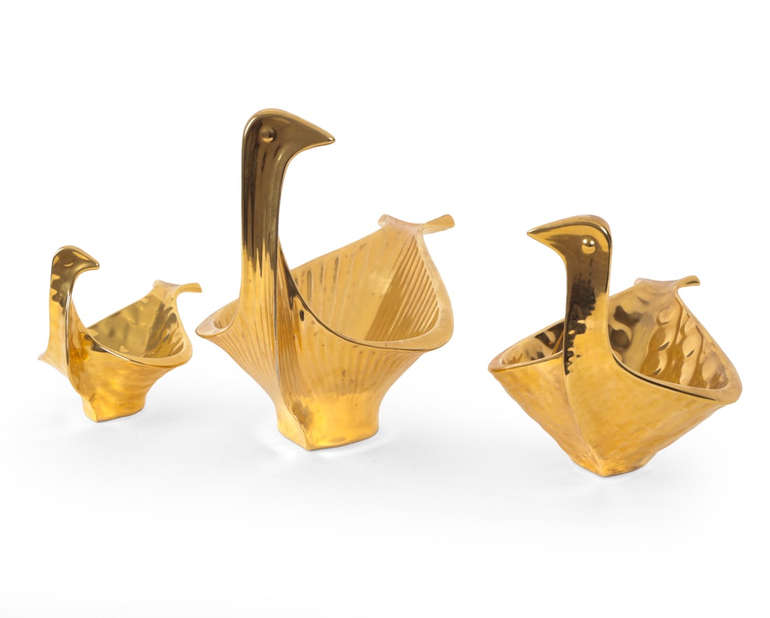JONATHAN ADLER MENAGERIE GOLD BIRD TRINKET DISHES: Grouping of three ceramic bird trinket dishes with a gold-tone finish. Marked on undersides. Dimensions: H 9.5" x W 7.5" x D 14.5? Condition: Wear consistent with age and use including light scuffs, s