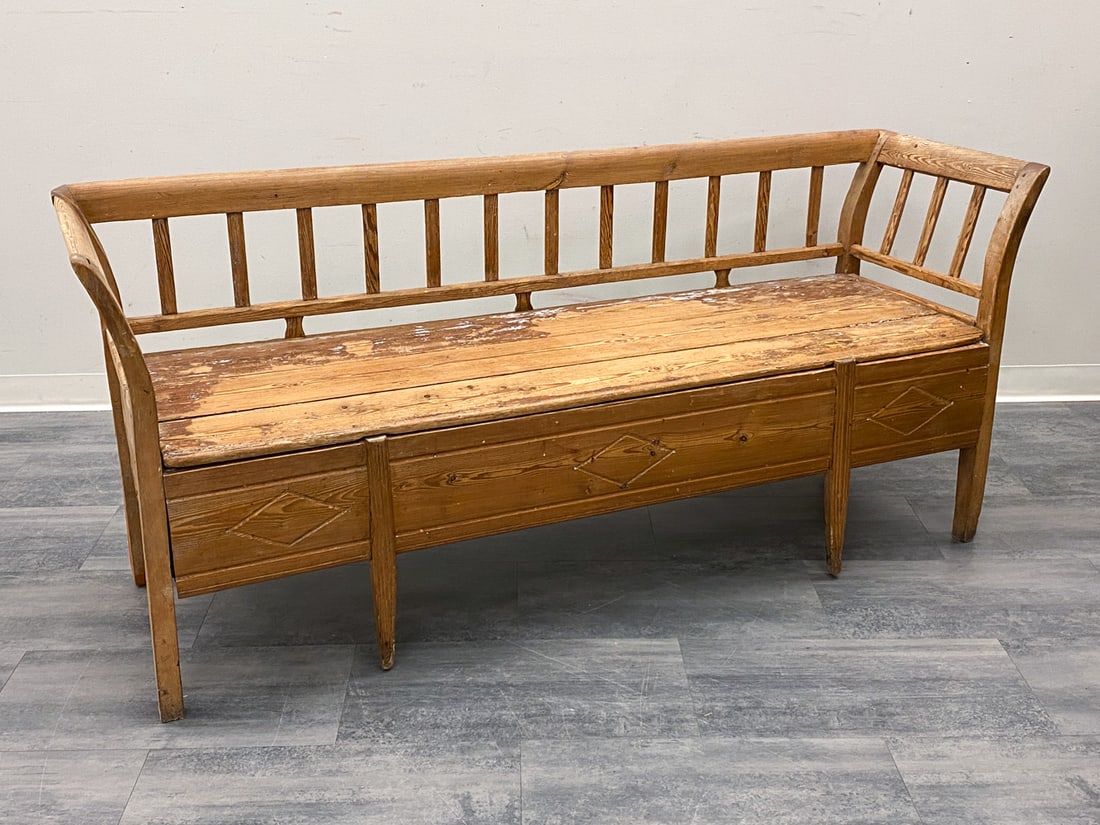 ANTIQUE SWEDISH PINE BENCH: Antique bench with storage underneath. Sweden, circa 19th century. Dimensions: H 32" x W 74" x D 23" x SH 19 Condition: Wear consistent with age and use. Old worming, not active, soiling, paint