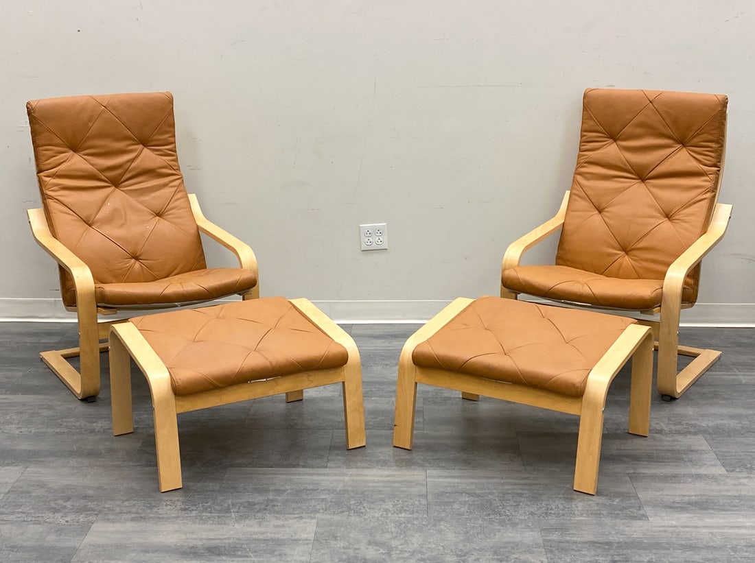 PAIR IKEA "POANG" LEATHER LOUNGE CHAIRS & OTTOMANS: Designed by Noboru Nakamura for Ikea. Marked to frame of one ottoman. Bentwood beech frame and cognac leather upholstery. With two ottomans. Sweden, 20th century. Dimensions: H 41.5" x W 27" x D 33" x