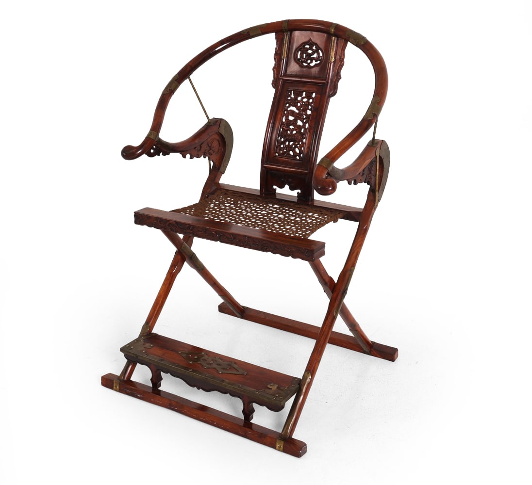 CHINESE ROSEWOOD HORSESHOE-BACK FOLDING CHAIR: Rosewood frame with rope seat and brass hardware. China, late 19th or early 20th century. Dimensions: H 45" x W 30" x D 28" x SH 22.75". Condition: Scuffs and rubs to wood. Previous repair to edge of