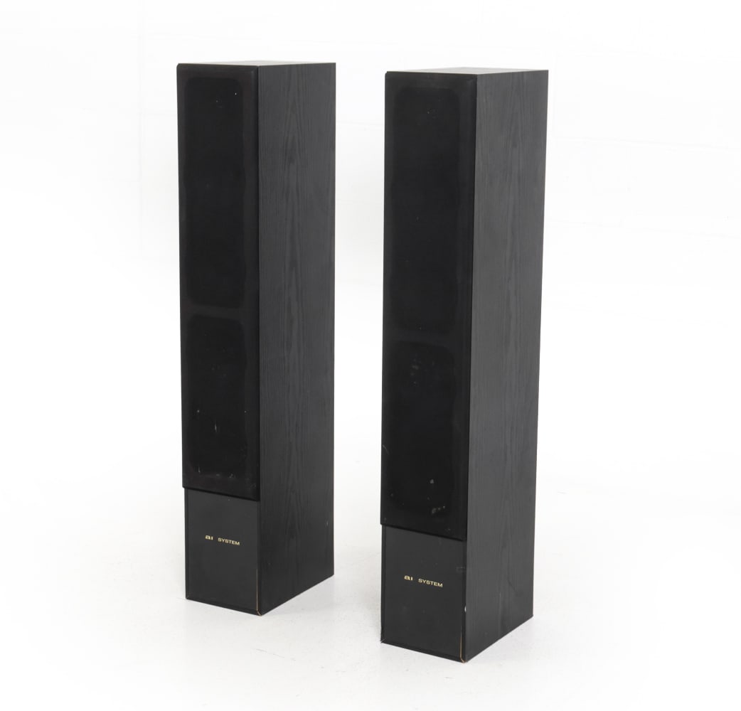 PAIR OF AI-SYSTEM FLOOR STANDING TOWER SPEAKERS: Marked on backside and front. Black lacquered wood with front mesh screen where speakers are. 20th century. Dimensions: H 39.5" x W 6.75" x D 11" Condition: Untested. Scuffs and dings, especially