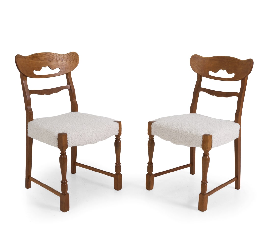 PAIR KJAERNULF STYLE DANISH OAK DINING CHAIRS: Carved oak frame with turned legs and boucle seats. Denmark, circa 1960s. Dimensions: H 34" x W 18" x D 20" x SH 18" Condition: Watermarks, scuffs, wear of finish, and discoloration. Recently reuphols