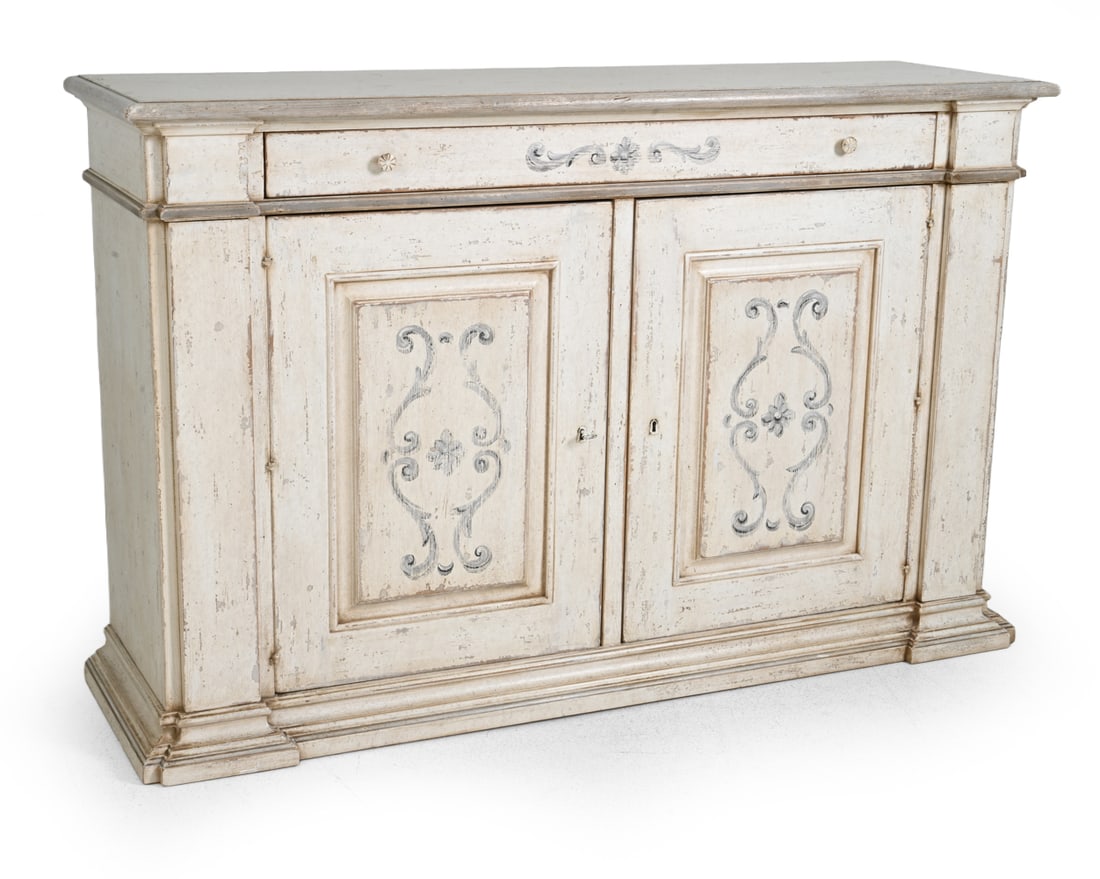 ITALIAN COUNTRY STYLE PAINTED BUFFET SIDEBOARD: Key included. Carved design with painted distressed finish and carved scrolling foliate and medallion motifs. Marked "Made in Italy" inside of door, 20th century. Dimensions: H 44.5'' x W 68.25'' x D