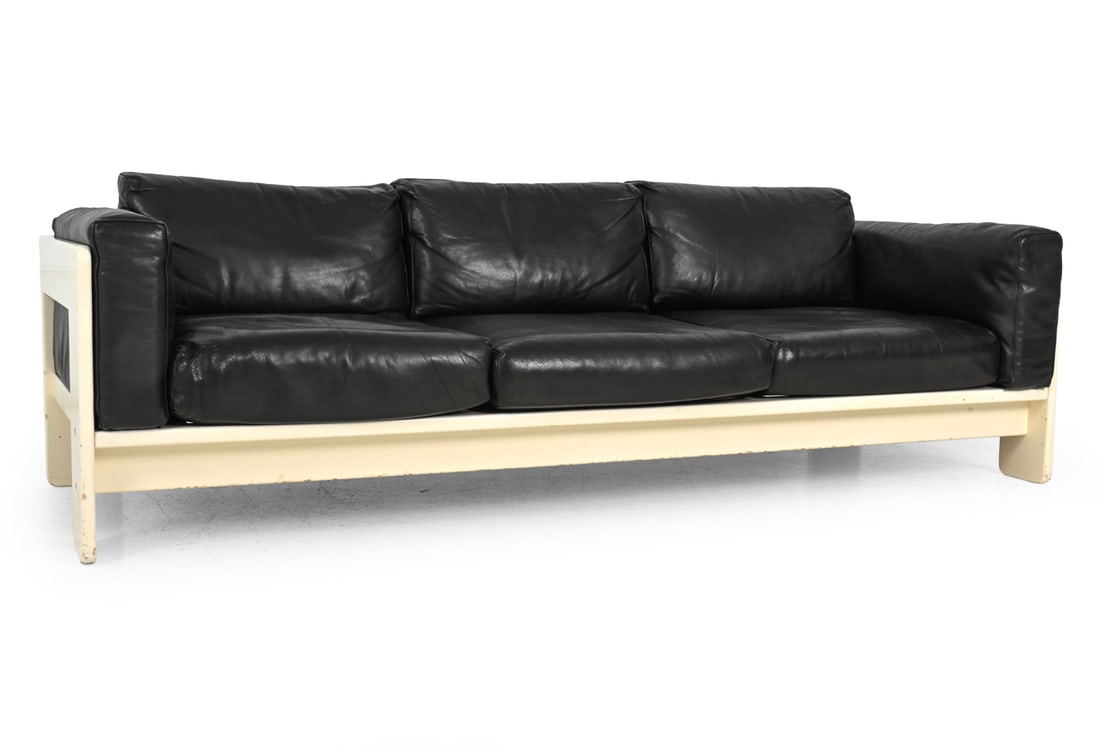 AFRA & TOBIA SCARPA FOR KNOLL "BASTIANO" SOFA: Three seater sofa with white lacquered wooden frame and black leather seat cushions. Apparently unmarked. Italy, circa, 1970s. Dimensions: H 29" x W 83.5" x D 31.25" x SH 14.5" Condition: Cracking, cr