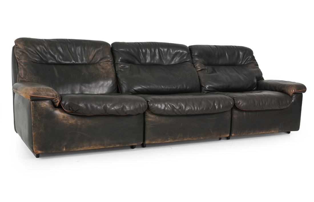 CARL LARSSON FOR DE SEDE DS-66 LEATHER SOFA 1970S: De Sede DS 66 three seater sofa in dark tone leather. Marked to bottom "deSede Exclusive". Switzerland, circa 1970s. Dimensions: H 31.25" x W 94.5" x D 34" x SH 15.5" Condition: Scuffs and scratches. 
