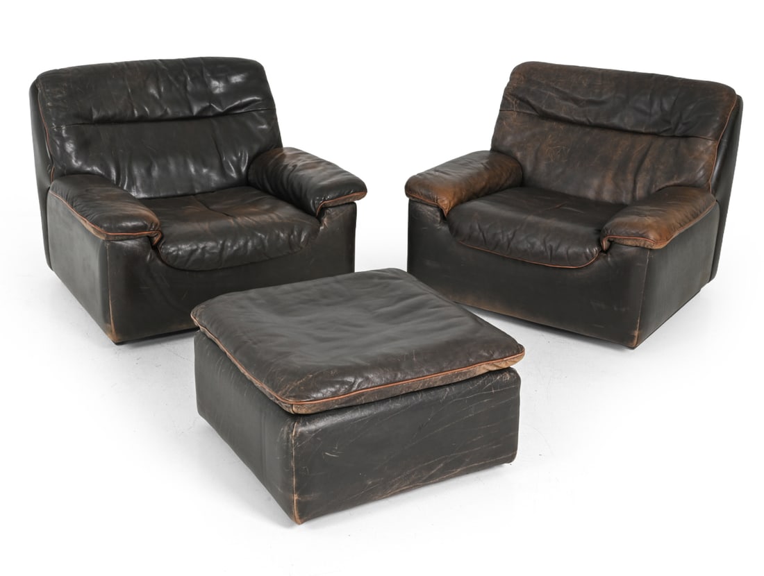 PAIR CARL LARSSON DE SEDE DS-66 CHAIRS & OTTOMAN: Carl Larsson for De Sede DS-66 lounge chairs and matching ottoman upholstered in brown leather. Switzerland, Circa 1970s. Dimensions: H 30.5" x W 36.5" x D 34" x SH 15.5" Condition: Scuffs and scrapes