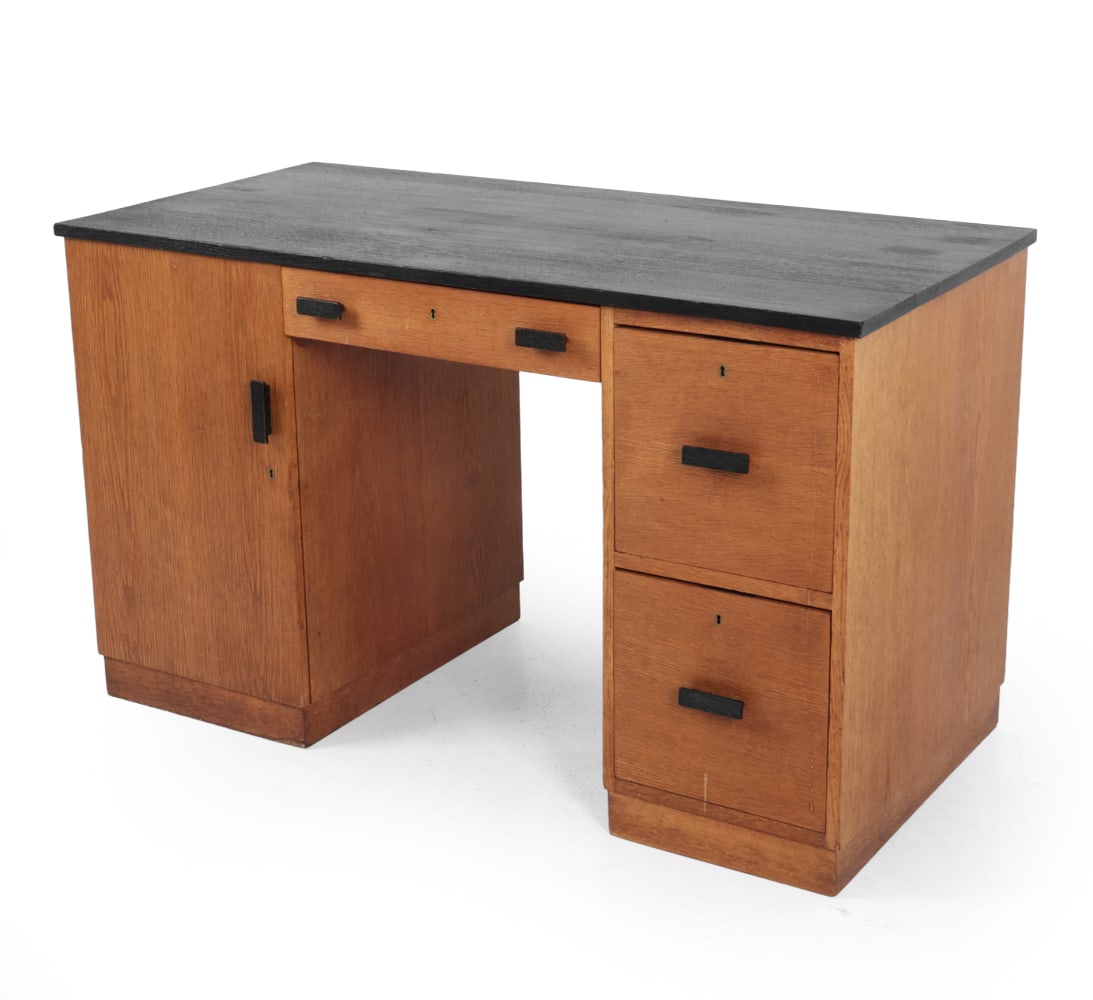 BRAAKMAN STYLE DUTCH OAK WRITING DESK C. 1960S: Double-pedestal writing desk with drawers. Black top and drawer pulls. Netherlands, circa 1960s. Dimensions: H 29.5? x W 50? x D 24.5? Condition: Some water stains on drawers. Joint separation to top.