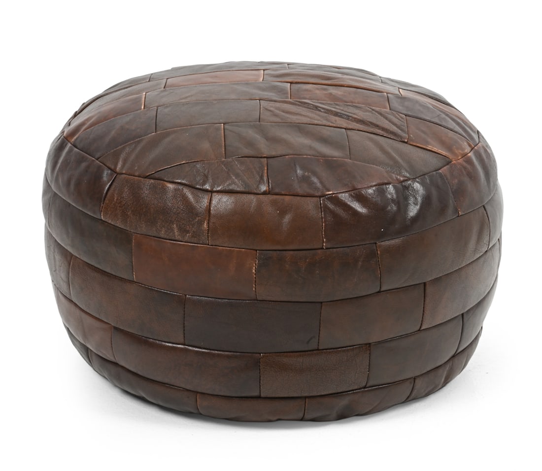 DE SEDE STYLE SWISS LEATHER POUF OTTOMAN C. 1970S: Unmarked. Switzerland, circa 1970s. Dimensions: H 13" x Dia 20" Condition: Rubs and spots of discoloration to leather. Wear consistent with age and use.