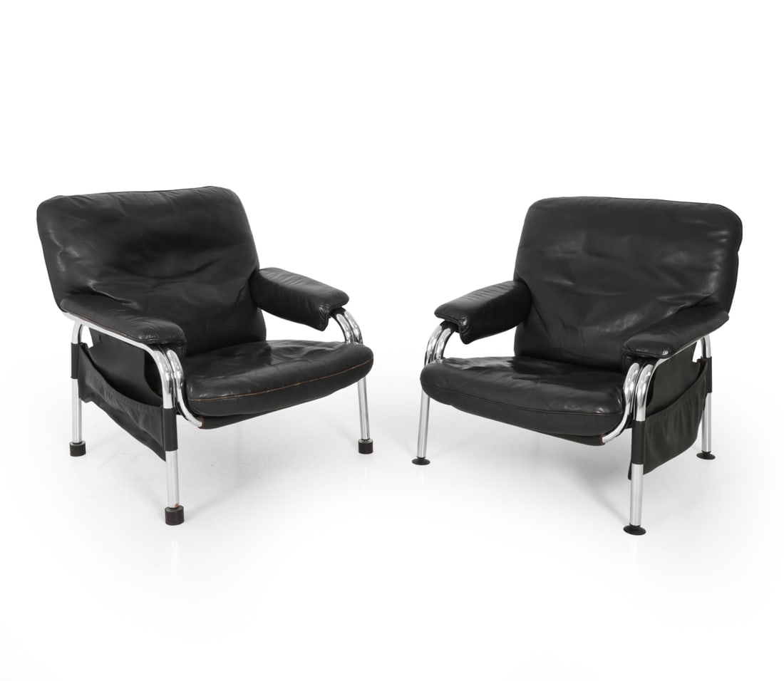 EICHENBERGER FOR DE SEDE "KANGAROO" LOUNGE CHAIRS: Designed by Hans Eichenberger for De Sede. Black leather and chrome steel frame. Magazine holder hangs from armrest. Apparently unmarked. Switzerland, circa 1970s. Dimensions: H 33.5" x W 32.5" x D