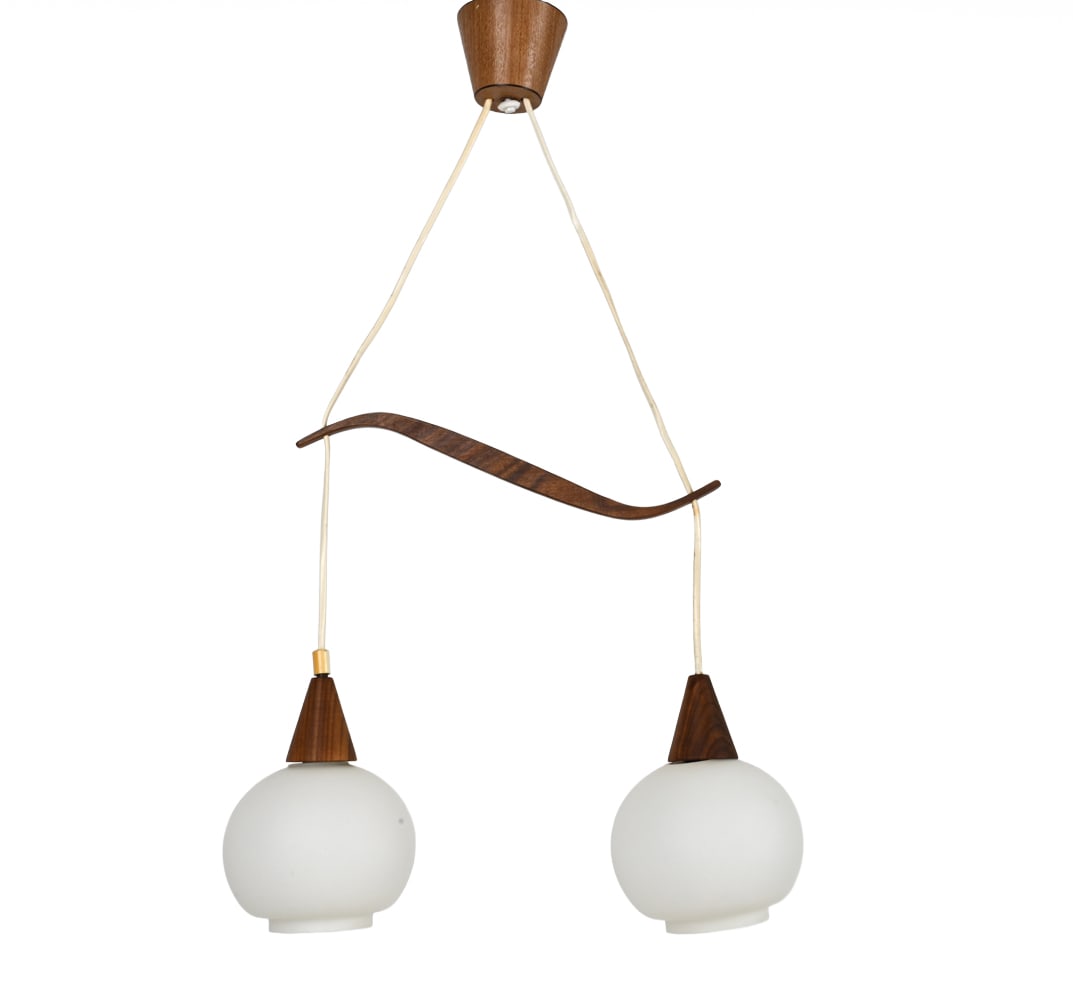 SCANDINAVIAN WALNUT & GLASS PENDANT LIGHT: White glass globes with walnut details. Adjustable. Dimensions: (Each fixture) H 8" x Dia 5.5" Condition: Flea bites to top and bottom rims of glass. Rubs to wood and spots of soiling to cords.