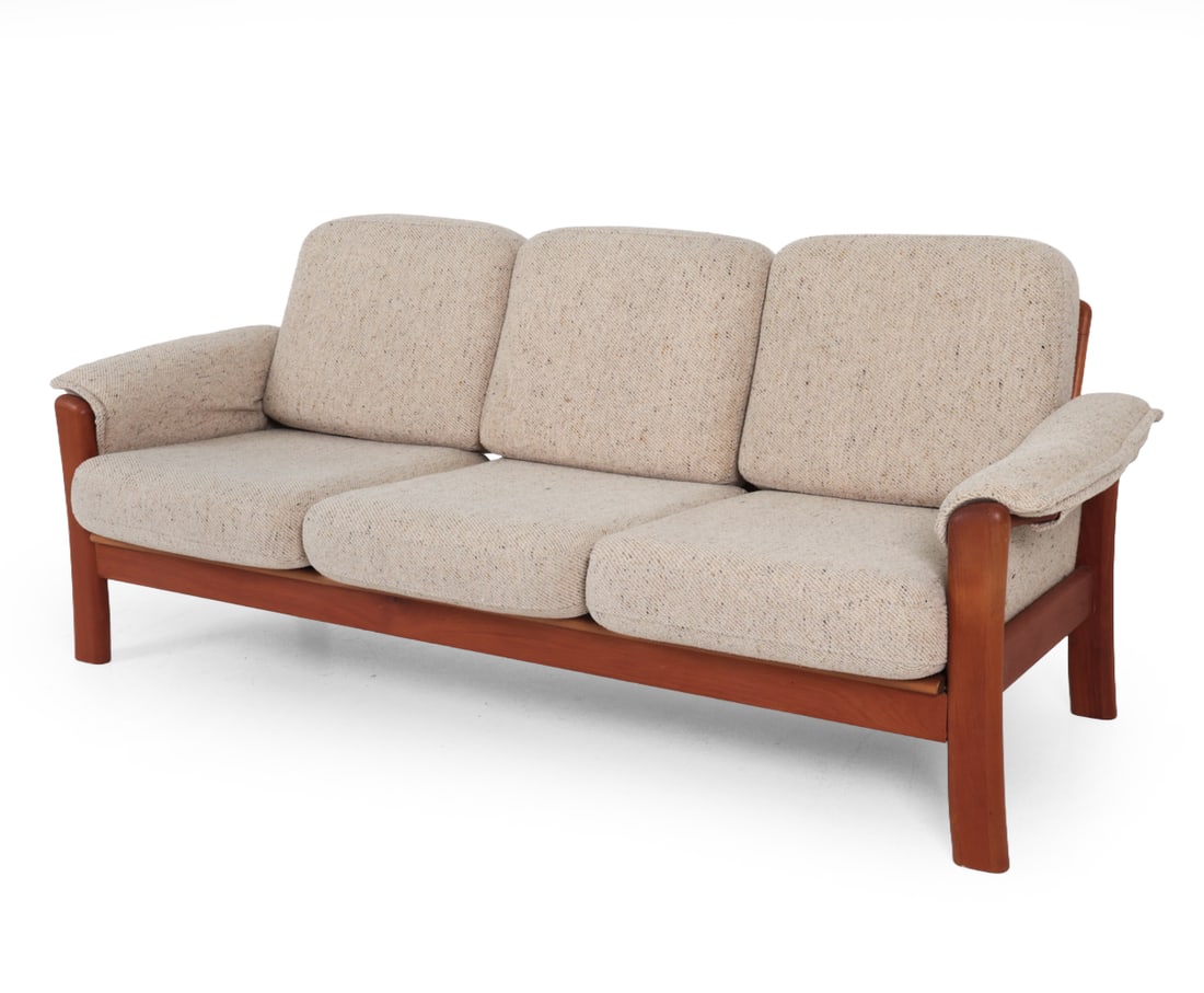 DYRLUND STYLE DANISH TEAK SOFA C. 1970S: Three seater sofa in teak frame. Beige tone upholstery with wrap-around arms. Denmark, circa 1970s. Dimensions: H 32" x W 78" x D 31? x SH 17? Condition: Some light sun fading. Wear consistent with