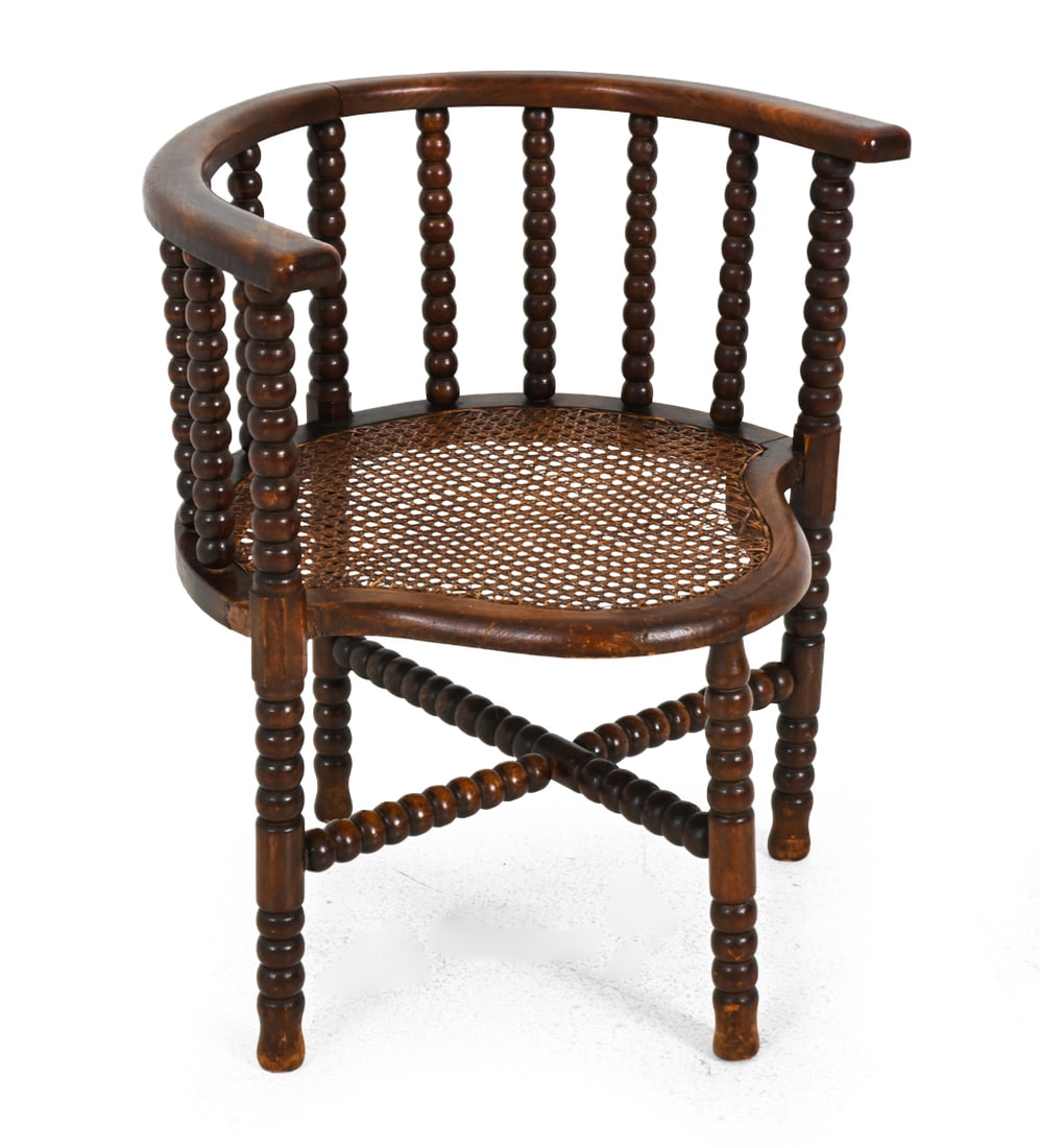 DUTCH BOBBIN TURNED OAK & CANE CORNER CHAIR: Corner armchair featuring bobbin-turned spindle work with a curved horseshoe-shaped armrest frame and a woven cane seat. Netherlands, early 20th century. Dimensions: H 25.25" x W 23" x D 20" x SH