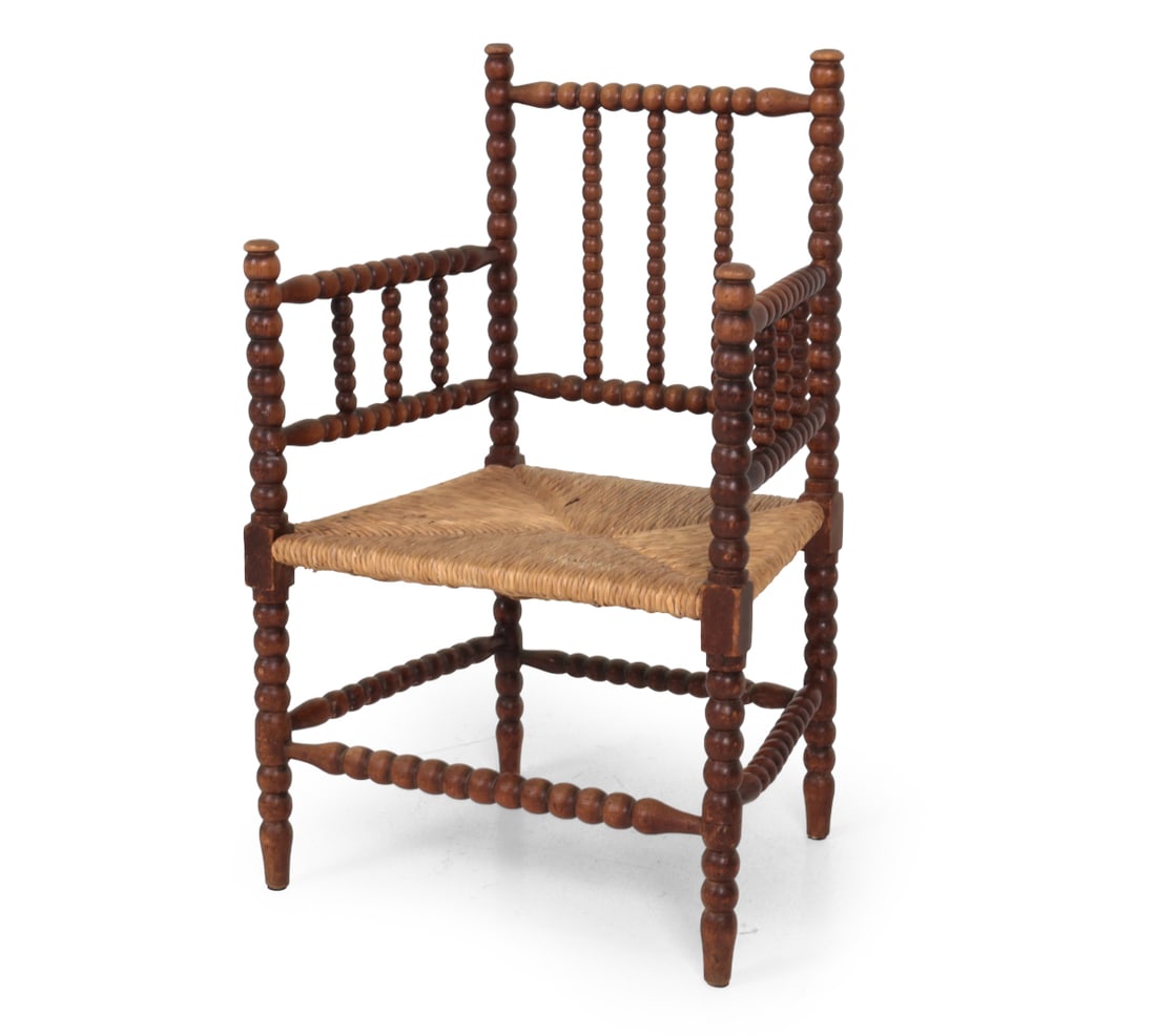 DUTCH BOBBIN TURNED OAK & RUSH ARMCHAIR C. 1930S: Bobbin turned oak frame with a woven rush seat. Netherlands, circa 1930s. Dimensions: H 34.5? x W 22.25? x D 17.5? SH15.5" Condition: Some scratches and wear to frames with loss of finish. Losses to r