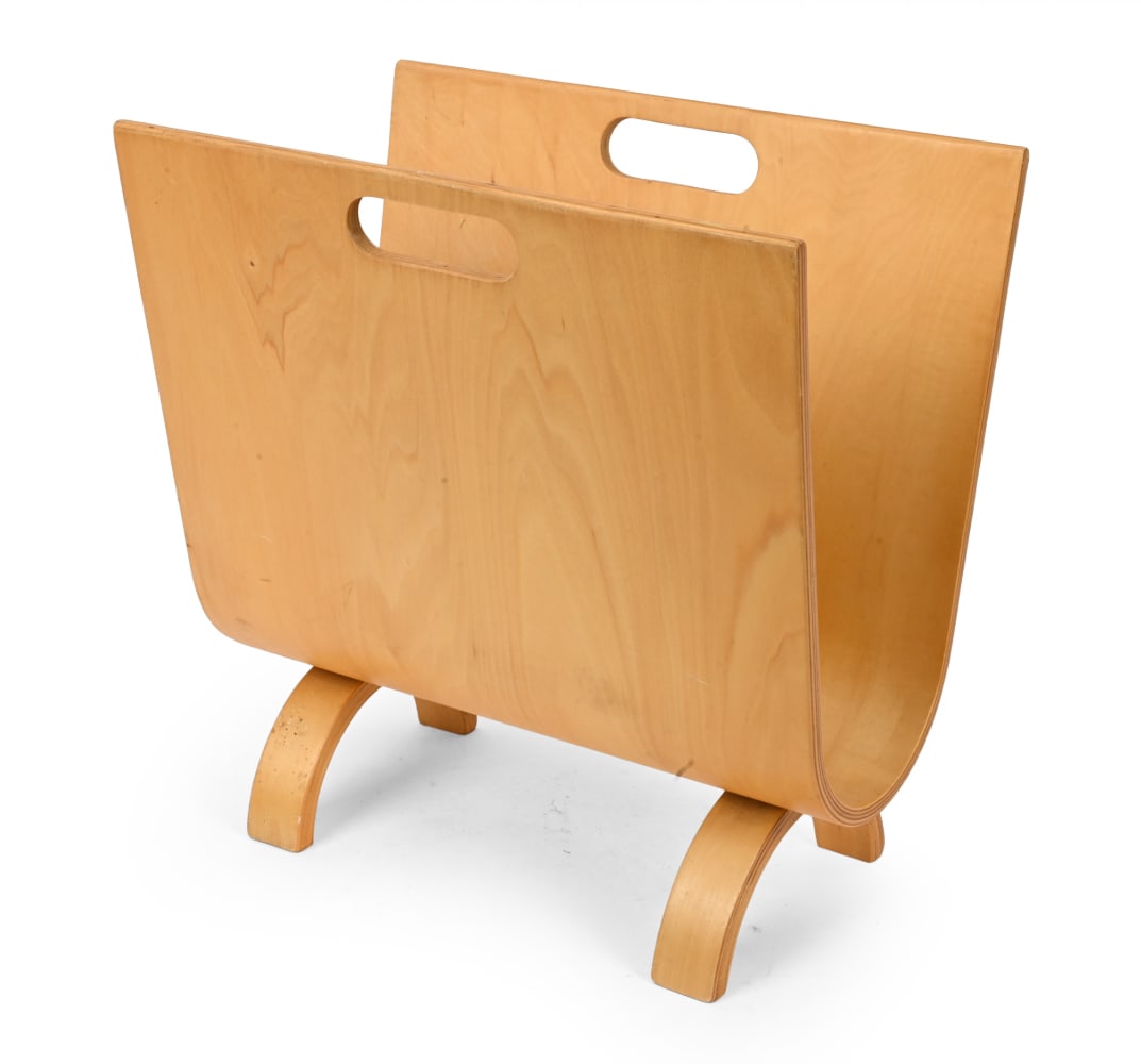 ALVAR AALTO STYLE BIRCH MAGAZINE RACK C. 1960S: Birch bentwood construction with cut-out handles and curved U form supports. Finland, circa 1960s. Dimensions: H 16.25" x W 16" x D 9.75" Condition: Scratches, scuffs and rubs, Minor edge wear. Wear
