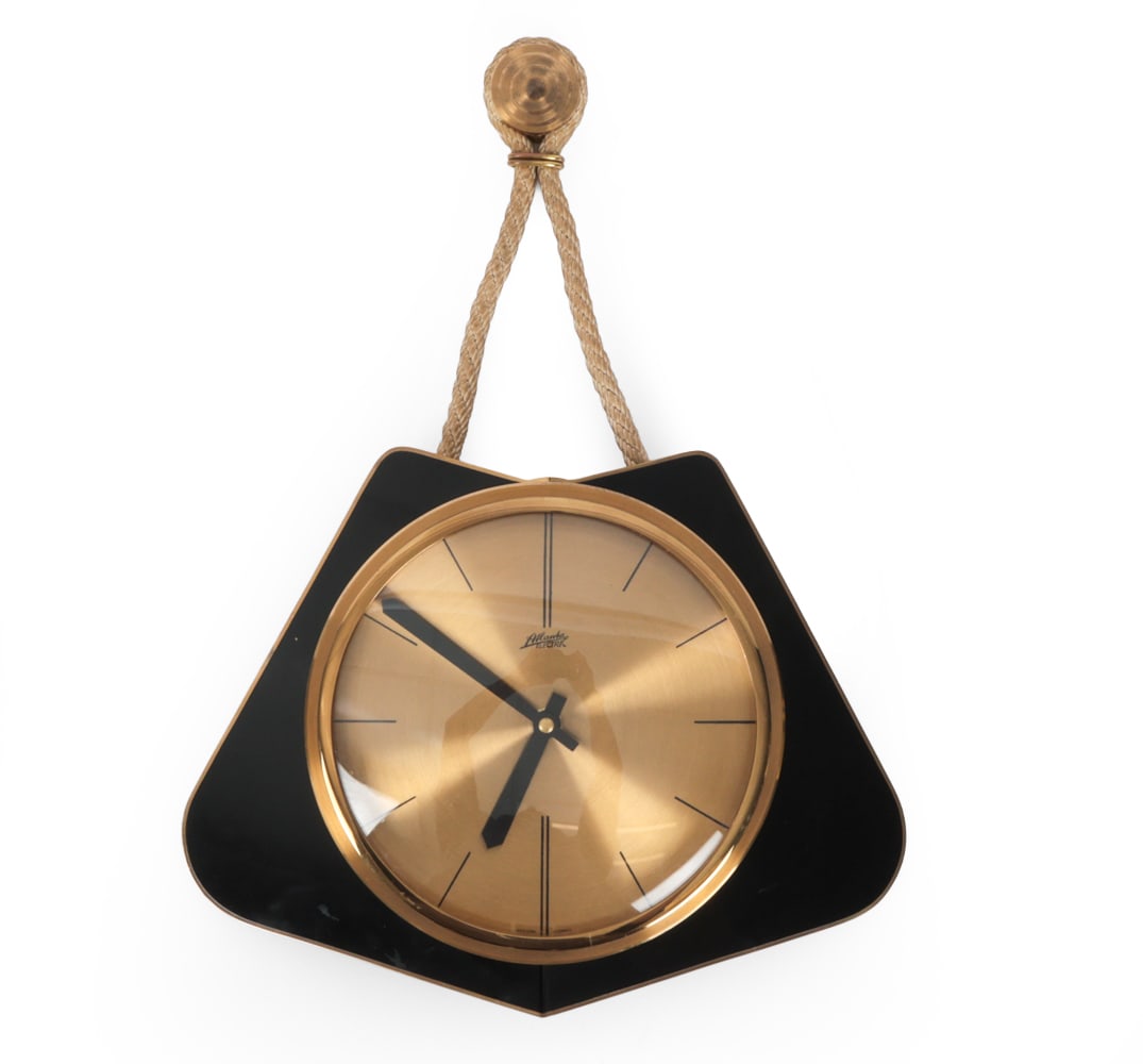 ATLANTA ELECTRIC GERMAN BRASS WALL CLOCK C. 1960S: Black lacquered body with brass bezel and rope suspension with metal back plate. Marked to dial, "Atlanta Electric". Germany, Circa, 1960s. Dimensions: H 17.5" x W 13 ? x D 3? Condition: Untested.