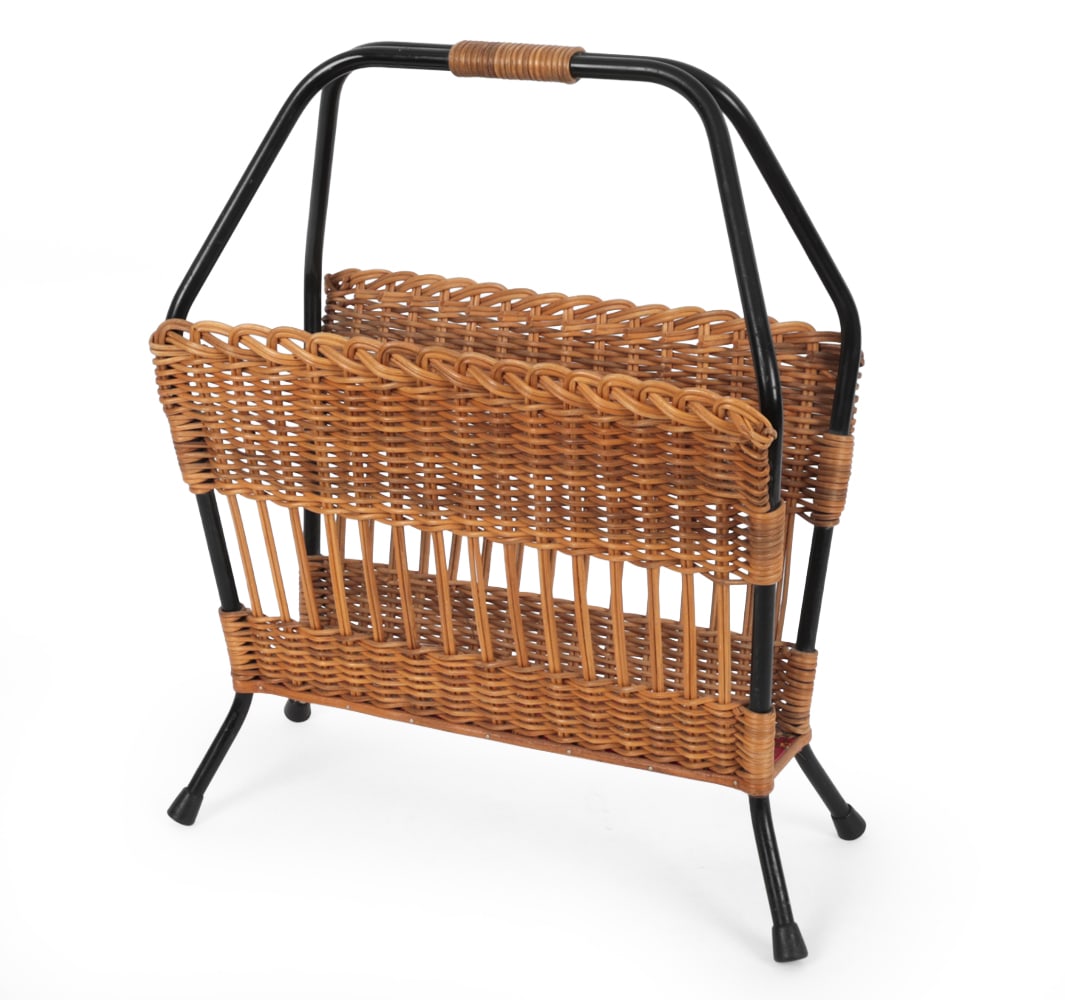 RAOUL GUYS STYLE FRENCH WICKER MAGAZINE RACK: Woven rattan body with carrying handle on a black metal frame. Apparently unmarked. France, circa 1950s. Dimensions: H 21" x W 18" x D 8" Condition: Separation to wicker. Minor scuffs and scratches. W