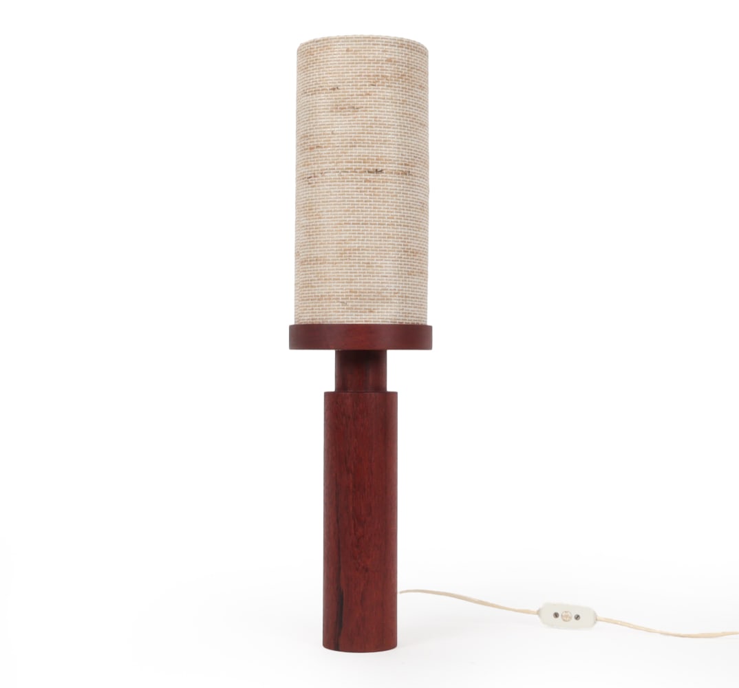 LARS TOLLER SWEDISH TEAK TABLE LAMP C. 1960S: Teak column with tall cylindrical woven shade. Marked to base. Sweden, circa 1960s. Dimensions: H 23.5" x W 5.75" x D 5.75" Condition: Some deformation to shade. European plug, wiring untested. Wear