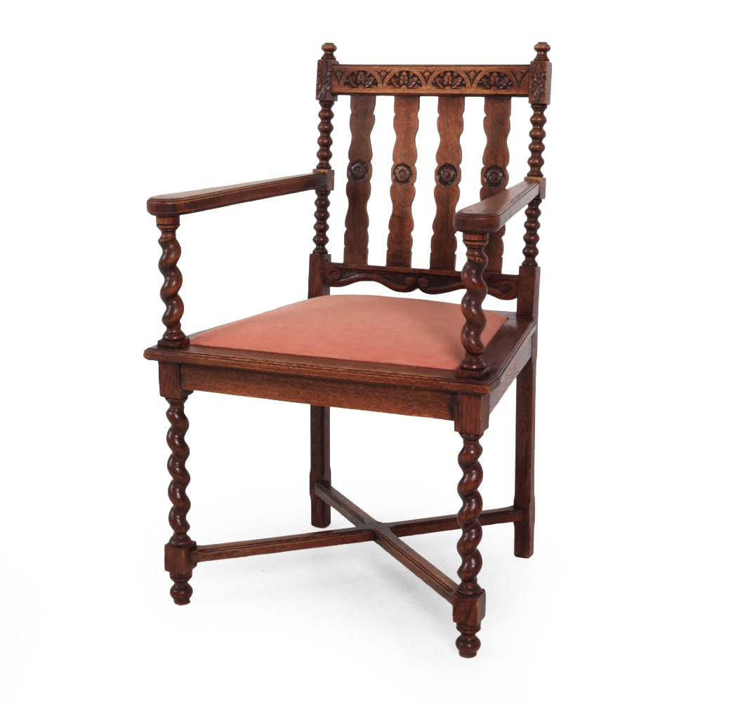 BAROQUE REVIVAL STYLE DUTCH CARVED OAK ARMCHAIR: Bobbin turnings, scalloped splats, and carved motifs. Early 20th century. Dimensions: H 36.5'' x W 24.5'' x D 20.75'' x SH 18.75'' Condition: Some scratches. Sun faded. Some dark marks on the back. We