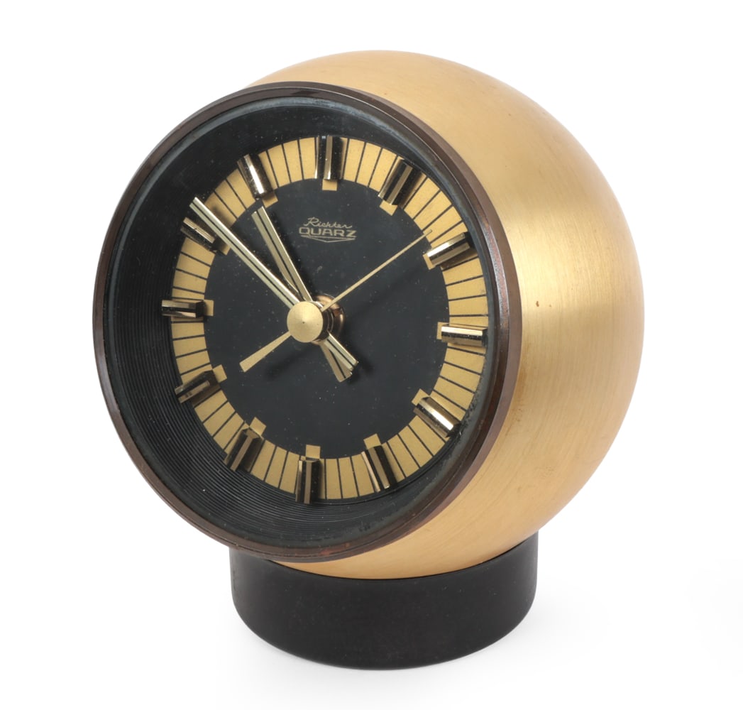 RICHTER QUARTZ GERMAN BRASS TABLE CLOCK C. 1960S: Marked to dial. Germany, circa 1960s. Dimensions: H 6.75" x W 5.25" x D 5.25 " Condition: Time keeping untested. Tarnish to brass. Small indent to top. Couple of very light rubs, minor scuffs. Wear co