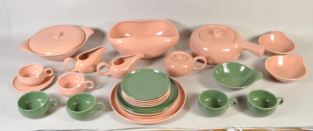 RUSSEL WRIGHT (AMERICAN 1904 - 1976): 26 pieces of dinnerware - CORAL COLOR- 1 bowl, 1 covered casserole, 1 covered dish, 1 suger bowl, 2 creamers, 2 cups & 1 saucer, 2 lug bowl, 4 - 4" small plates, 2- 6" plates, 1-10" plate. CEDAR GREEN