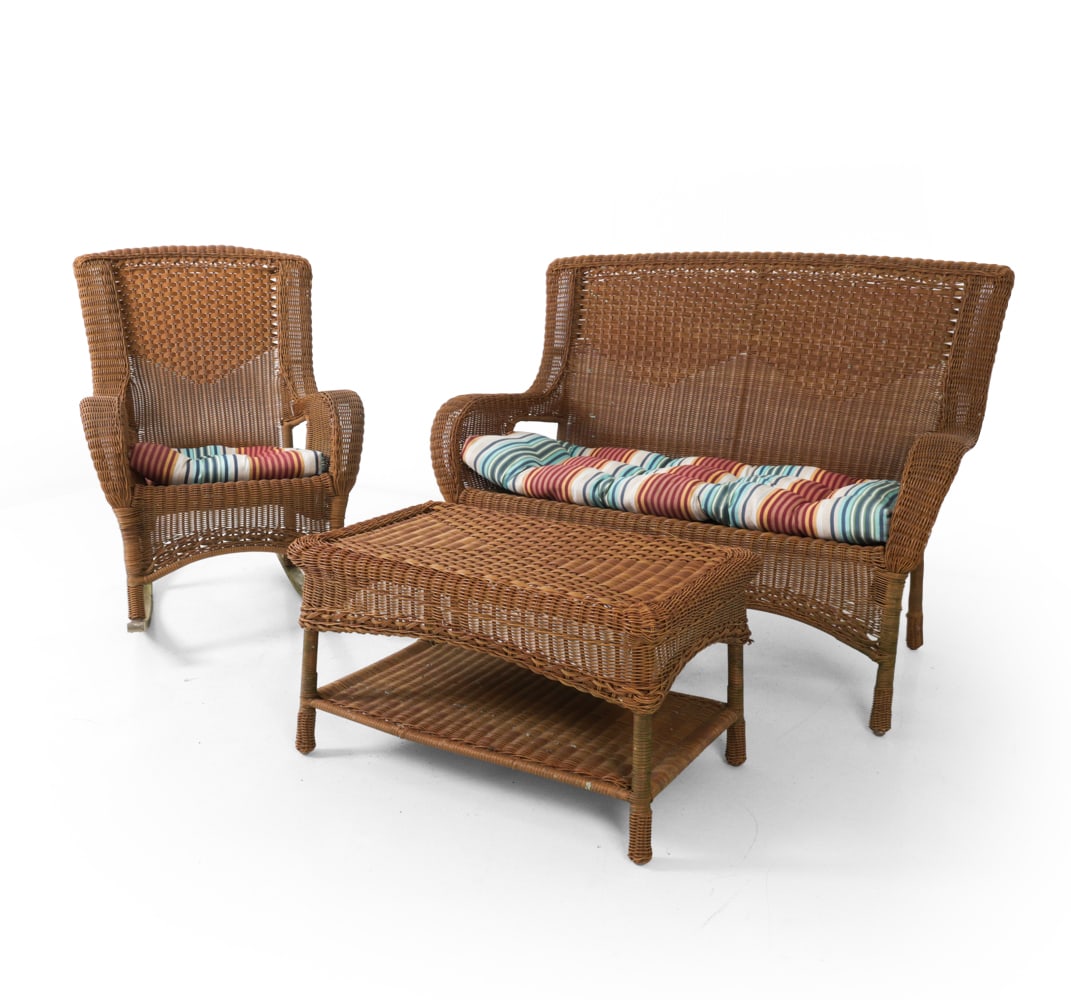 FAUX WICKER PATIO SUITE: Includes loveseat, coffee table, and rocking chair. 20th century. Dimensions: (love seat) H 40" x W 52" x D 28" x SH 19" (table) H 18" x W 33" x D 20" Condition: Showing signs of wear consistent with 