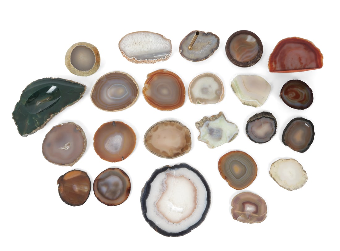SLICES GEODES GROUPING INCL. AGATE: (23) Some have been made into coasters, one is a pen holder. Includes mainly agate. Dimensions: (Largest) H 4.25" x W 8.25" Condition: Light scuffs and nicks. One slice has split into three. Wear