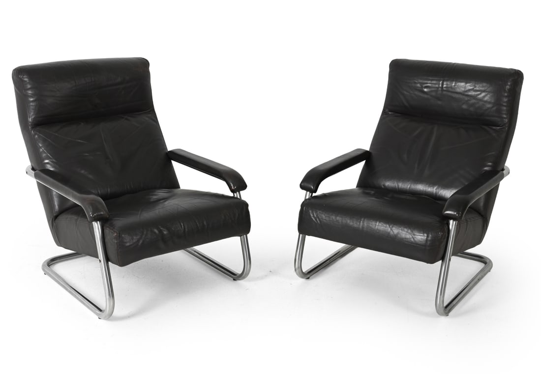 PAIR JAN DES BOUVRIE STYLE LEATHER LOUNGE CHAIRS: Black leather upholstered seat and segmented back cushions. Netherlands, circa 1970s. Dimensions: H 34.5" x W 28.25" x D 35" x SH 16.5" Condition: Scuffs and scratches to leather. Fading and discolora