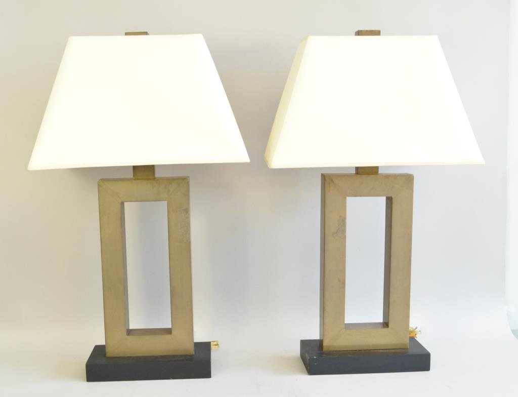 PAIR OF DECORATIVE BRASS TABLE LAMPS: C. 1980S In the style of Donald Deskey Dimension: H 31" X W 11" X 5" (at base) Condition: Good, one piece of tape on each, need polishing. From the Estate of Interior Designer Stanley Hura