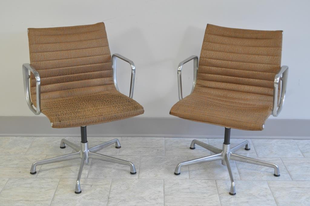 PAIR OF HERMAN MILLER ALUMINUM SWIVEL CHAIRS: Both are press stamped Herman Miller Logo Dimension: H 33" X L 23" X W 21" Condition: Good. The upholstery on one seat is lifting. Needs to be retacked. Some corrosion & scuffs to the arms