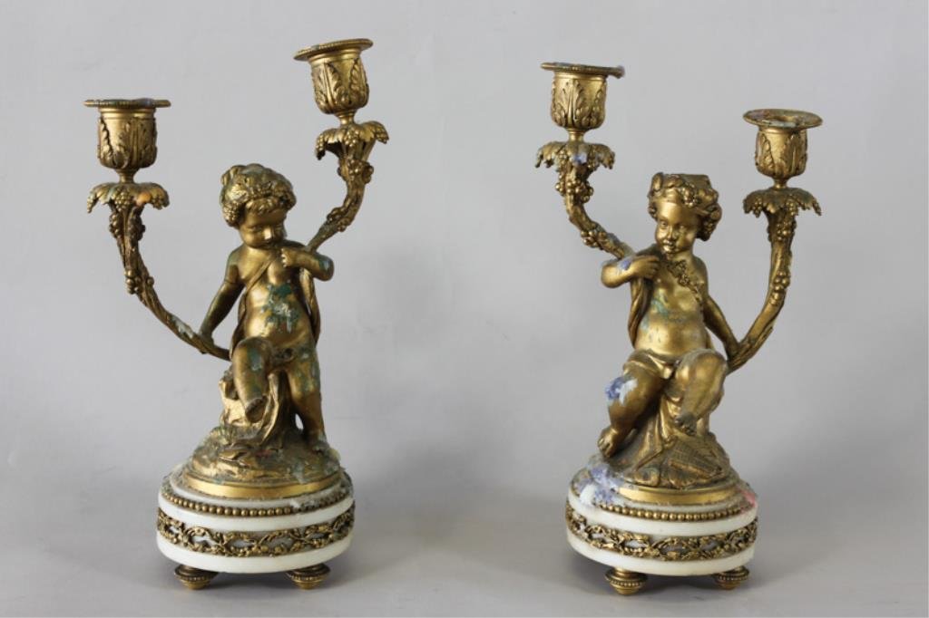 PAIR OF 19TH C. BRONZE CLODION PUTTI CANDLEABRAS: On footed, white alabaster bases. Both are signed Dimension: H 12" X W 6.5" Condition: Excellent with heavy wax from candle use. From a Westport, CT Estate