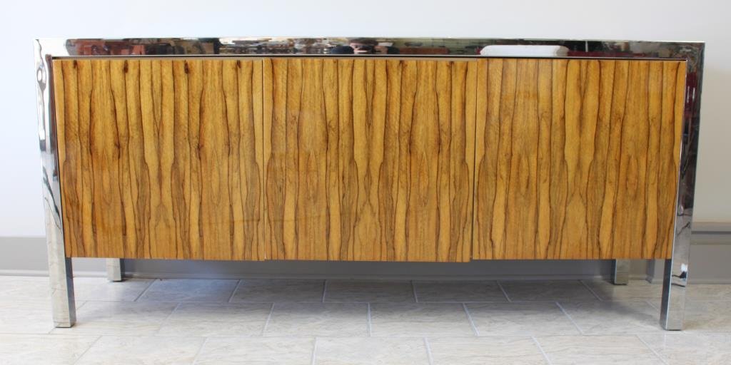 RARE PACE COLLECTION KOA WOOD SIDEBOARD: Highly figured and iridescent fiddleback koa wood, heavy polished steel frame supports. Finished on all four sides. Three cabinet doors open and each contain three drawers. Dimensions: L 72" x H 33" x