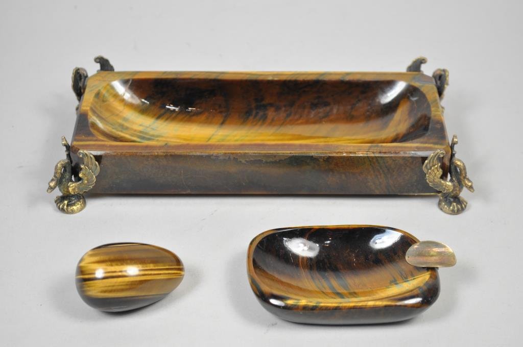 CHAUMET FRENCH TIGER'S EYE QUARTZ DESK SUITE: With silver gilt to ashtray, and silver gilt swan footings to pen holder, egg is not known to be original with set Dimensions (pen holder): L 9" x W 4" x H 1 1/2" Condition: A restoration to a fractur