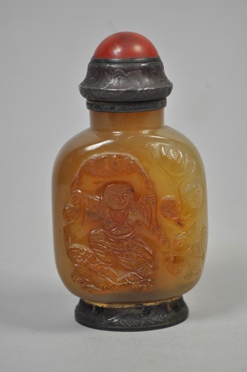 YELLOW HARDSTONE SNUFF BOTTLE: Silver mounted, signed "Maquet", with carnelian cap, the body carved with two figures, bears French hallmarks, slotted base Dimensions: L 2" x W 1 1/4" x H 3 1/2" Condition: very good, some wear to bo